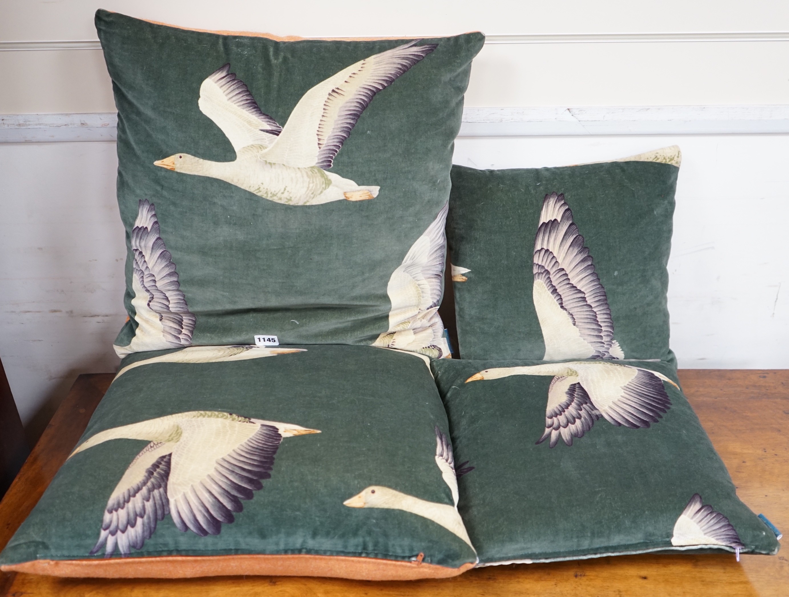 Two pairs of cushions decorated with geese